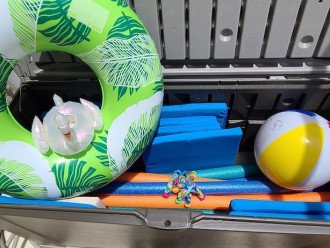 Outside storage bin has Patio chair cushions and pool floats