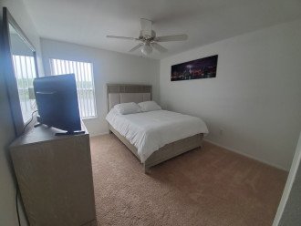 3rd bedroom- queen bed, large closet with Samsung TV