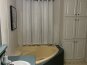 Tub and linen closet in master bath #1