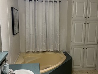 Tub and linen closet in master bath #1