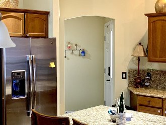 Kitchen-Large side by side fridge with ice /water. Home entry in center of photo