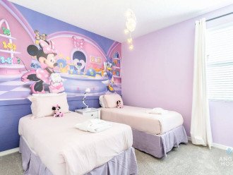 Bedroom 2 is Minnie’s princess room with two twin beds and a shared bathroom w/B9.