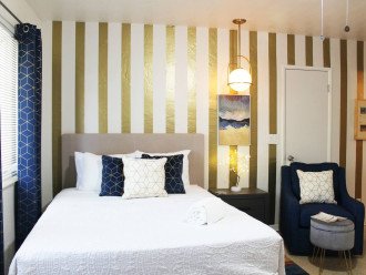 Stylish art deco themed bedroom area with bedside reading lamp on a dimmable switch.