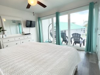 Master bedroom w/ 32" SMART TV and private balcony access