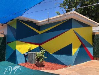 Our new one-of-a-kind Bauhaus inspired mural in the private back patio area! Its geometric shape and colors are the perfect backdrop for your outdoor relaxation.