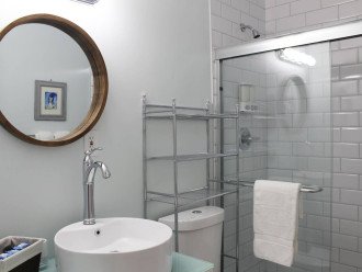 En suite master bathroom. This bathroom has a semi-frameless shower stall. Near the sink, you'll find organic moisturizer and hand soap. In each bathroom, you'll find Pinzon Blended Egyptian White Cotton Towels.