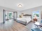Bedroom 3 has a king bed, smart TV, ensuite bathroom, sitting room access and balcony access