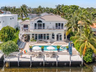 This modern coastal open floor plan villa offers waterfront views and access.
