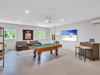 The game room features a pool table, 85' Smart TV, boardgames