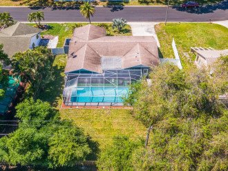 Aerial back view of our beautiful house showcasing our stunning heated pool. The property is surrounded by trees and is fully fenced. If you are interested in this property, send us an inquiry now!