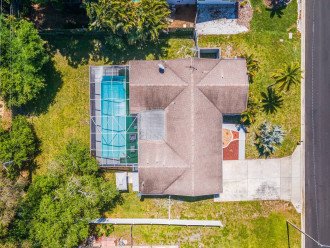 Aerial top view of our beautiful house showcasing our immaculate heated pool. The property is surrounded by trees and is fully fenced. If you are interested in this property, send us an inquiry now!