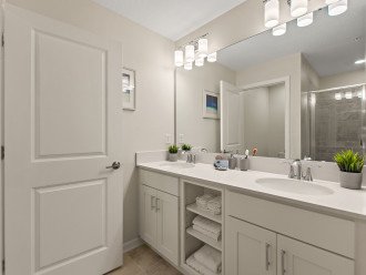 Family bathroom with double vanity and shower over bath