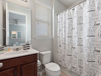Bathroom with shower over bath and individual vanity sinks