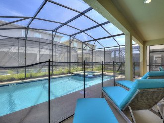 Pool deck furnished with loungers and table set