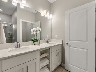 A large family bathroom is with double vanity and shower over bath.