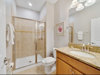 Walk-in shower and vanity mirror in one of the bedrooms