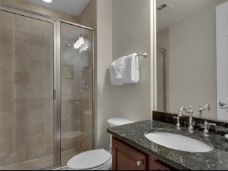 Twin guest room with private bathroom with walk in shower 