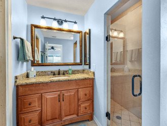 Primary bathroom with walk in shower and walk in closet.