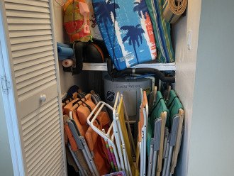 Closet is abundant with beach chairs, umbrella, toys, balls