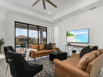 Living room with a smart TV and view of the heated saltwater pool as well as the freshwater canal.