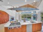 The kitchen has state of the art appliances, plenty of storage space, and excellent view of the pool and the waterway.