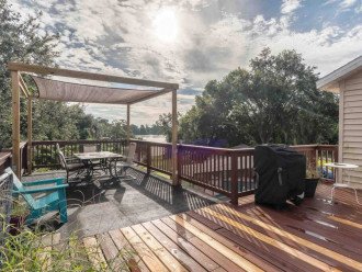 outdoor patio, pergola, and grill w/ view of the lake