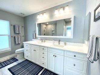 New master bath with walk-in shower, medicine cabinet, and large linen closet.