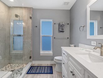 Large shower with bench seat.