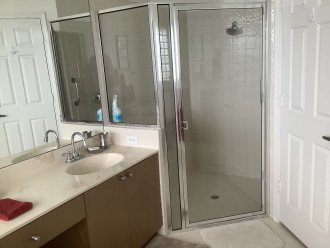 walk in large shower, separate sinks and private toilet closet