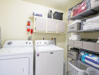 Laundry room w/ iron and ironing board; stocked with bath and beach towels
