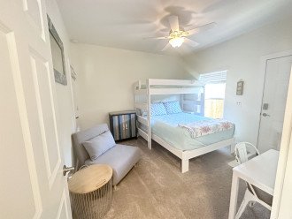Guest bedroom on the left side of hallway. One twin bunk and a queen bed.