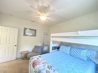 Guest bedroom on the left side of hallway. One twin bunk and a queen bed.