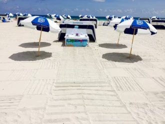 Beach resort amenities available with beach chairs and umbrellas