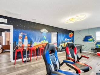 Pizza Planet themed game room. Gaming chairs for PS5 on a 65" TV!