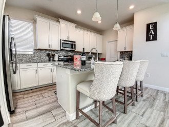 Fully Equipped kitchen with island seating and coffee bar.