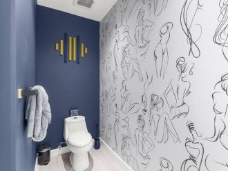 Our bathroom is anything but ordinary with a one-of-a-kind wall design featuring a hand-drawn woman that adds a touch of personality and character to our stylish and inviting space.