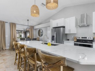 White quartz countertops provides plenty of space to lay out snacks and drinks