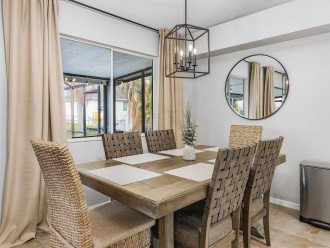 A dining area directly off the kitchen with views of the pool and living room.