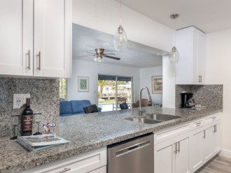 Enjoy the open-concept ambiance of this house and incredible views of Bahama Canal.Modern kitchen has granite counters, gas range, stainless steel appliances, dishwasher,minimalist glass-pendant chandelier lighting.
