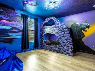 Black Panther Room with custom bunk bed, 43" TV, and murals of Avengers.