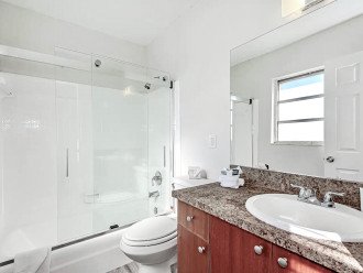 Bathroom with tub/shower and sliding glass door.
