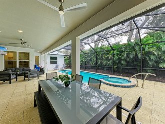 Outdoor living space with 50" outdoor TV, dining table for 6, pool, spa, perfect for lounging with the family