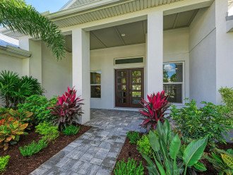 Delight in the, "Old Florida" landscaping as you approach the front door