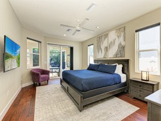 Unwind in the spacious master suite with King size bed, direct lanai access, and soothing artwork.