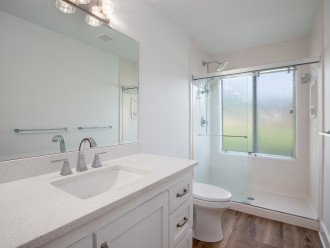 Large ensuite bathroom has walk in shower and dual vanities.