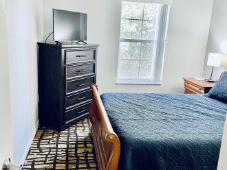 2nd bedroom with a queen bed and smart tv