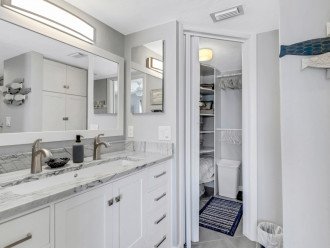 Master bath w/ double faucet trough sink, medicine cabinet, and walk-in closet.