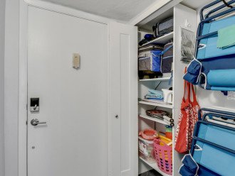 Entry closet with beach chairs, beach toys, and coolers.