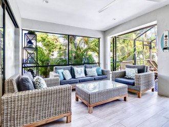 Covered, screened lanai with comfortable seating.