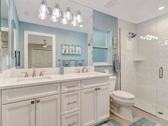 Master bath with two sinks, medicine cabinet, and large walk-in shower.